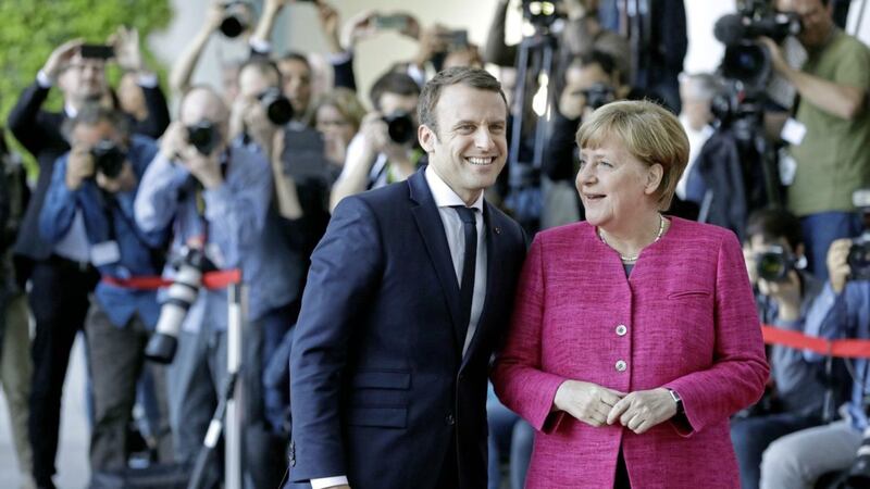 New French president Emmanuel Macron is welcomed by German chancellor Angela Merkel in Berlin yesterday, during his first foreign trip after his inauguration the day before PICTURE: Michael Sohn/AP 
