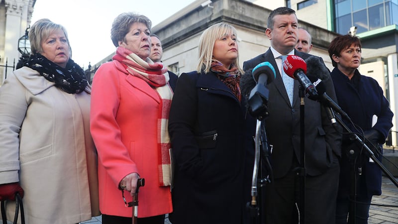 Emma Rogan (centre), whose father Adrian Rogan was killed in the 1994 Loughinisland pub shooting, speaks to the media alongside solicitor Niall Murphy outside Belfast's High Court&nbsp;