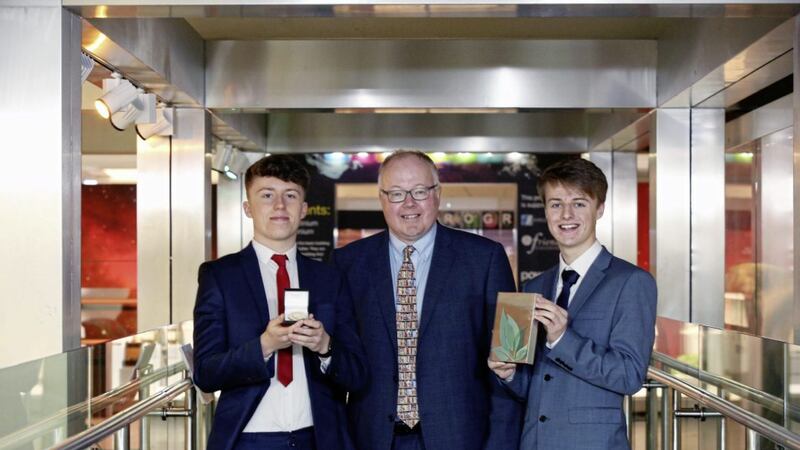 Jamie Brannigan (left), a former student of St Colman&rsquo;s College in Newry, won the Hans Sloane award for top marks in A level science while Matthew Vennard from Portadown College was awarded the Sloane McClay award for the highest marks in science and maths at GCSE level. They are pictured with Professor Tim Harrison of Almac 