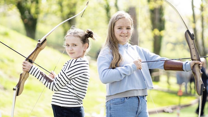 Beth (9) and Hannah (12) McConville enjoying the archery lane at the new Narnia Garden, a therapeutic space at Cancer Fund for Children&rsquo;s Daisy Lodge centre 