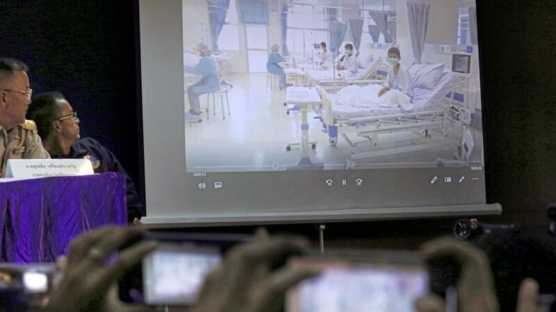 Members of the media try to photograph a projected image of the rescued boys in their hospital room during a police press conference in Chiang Rai province, northern Thailand onWednesday. Picture by Associated Press 