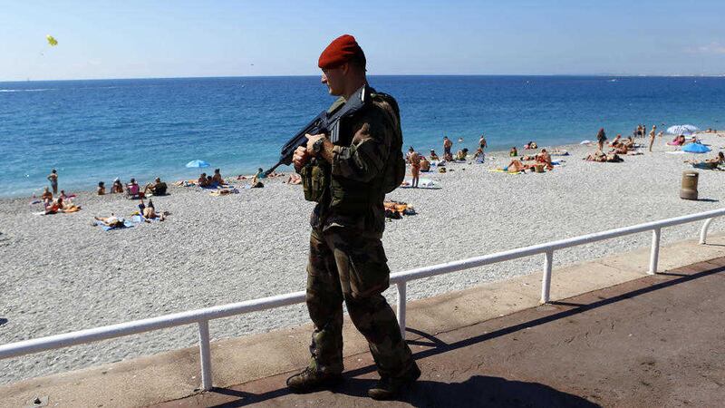 A French soldier patrols the famed Promenade des Anglais in Nice. Picture by Francois Mori, Associated Press