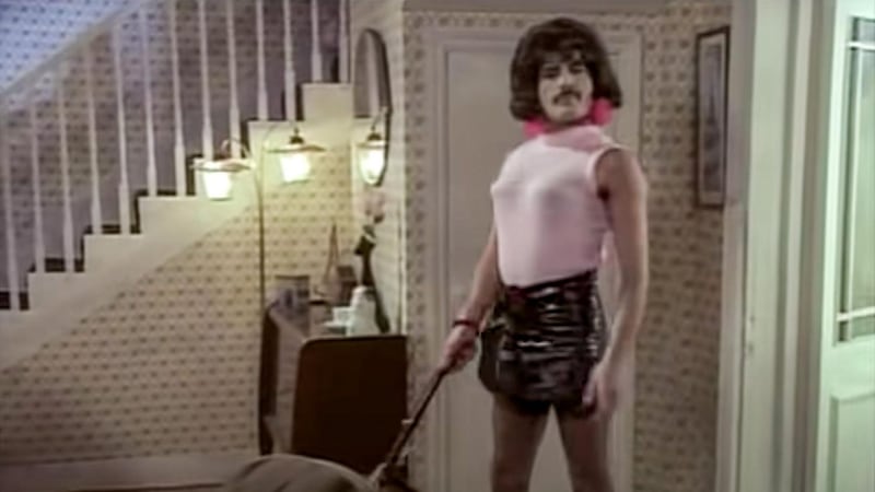 Photo taken from the  Queen video for I Want to Break Free with Freddy Mercury in a pink top and mini-skirt