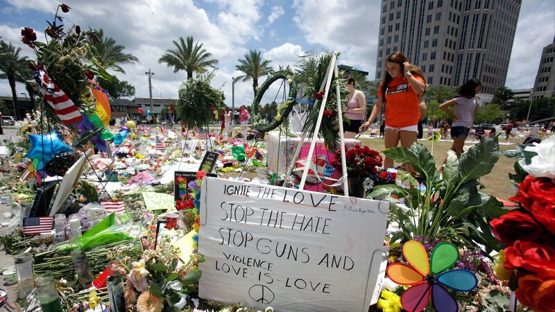 A makeshift memorial at the Dr&nbsp;Phillips Performing Art Center honoring the victims of the Pulse nightclub mass shooting continues to grow each day as visitors bring flowers, candle and other items in Orlando, Florida. Picture by&nbsp;John Raoux, Associated Press&nbsp;