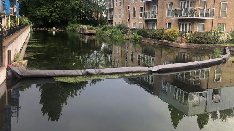 A boom installed in a millpond in Nash Mills (Brian Farmer/PA)