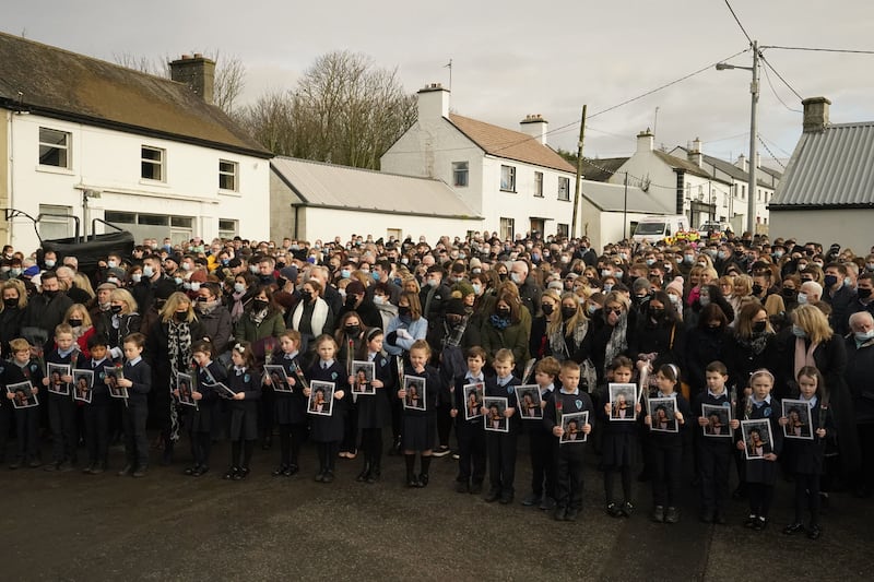 Schoolchildren taught by Ashling Murphy hold photographs of her as the cortege passes by on arrival at St Brigid's Church, Mountbolus, Co Offaly. Picture by Niall Carson/PA Wire &nbsp;