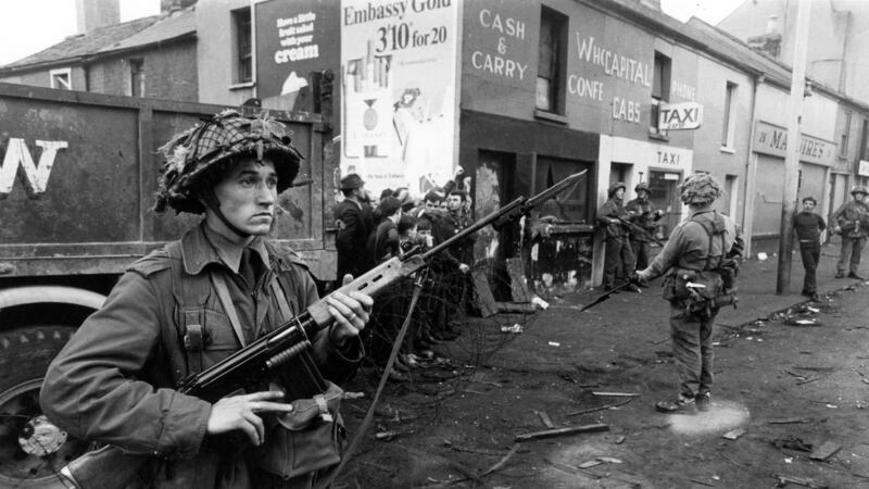 Newly-arrived British soldiers stand on guard in the Falls Road area of Belfast