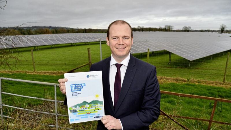 Economy minister Gordon Lyons with the newly-published &#39;Path to Net Zero&#39; energy strategy                                     