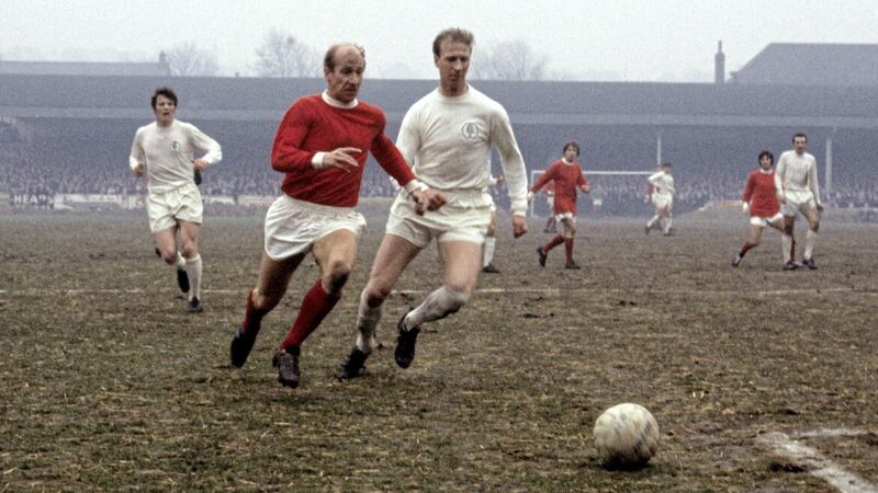 Bobby Charlton (left) takes on Jack.