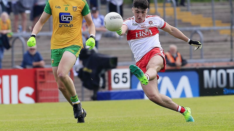 <address>Derry's Ben McCarron gets a shot away as Donegal's Shane McDevitt closes in Picture by Philip Walsh