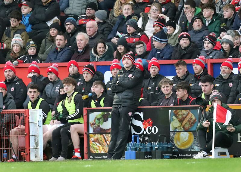 Tyrone joint manager Brian Dooher on his own without Feargal Logan in front of the Tyrone substitutes.