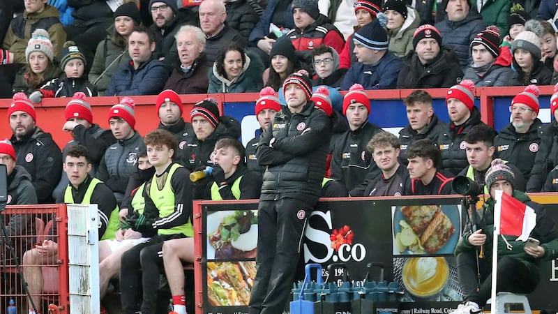 Tyrone joint manager Brian Dooher on his own without Feargal Logan in front of the Tyrone substitutes.