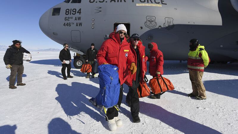 US secretary of state John Kerry, centre, disembarks from a US Air Force C17 Globemaster with the National Science Foundation's Scott Borg, right, at the Pegasus ice runway near McMurdo Station, Antarctica on Friday. Picture by Mark Ralston/AP&nbsp;