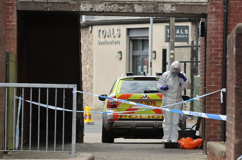 A police forensics officer at a property on James Street in Ballymena