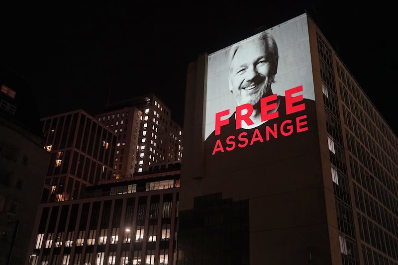 An image of Julian Assange is projected on to a building in Leake Street in central London to mark three years since his arrest and detention in Belmarsh Prison while the United States continues with legal moves to extradite him
