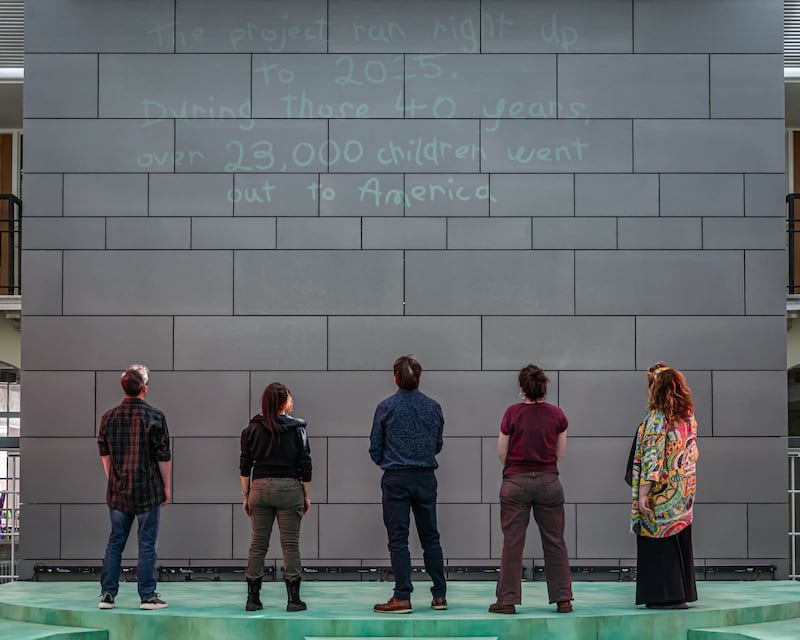Cast of Brassneck Theatre Company's production of Project Children looking at a wall