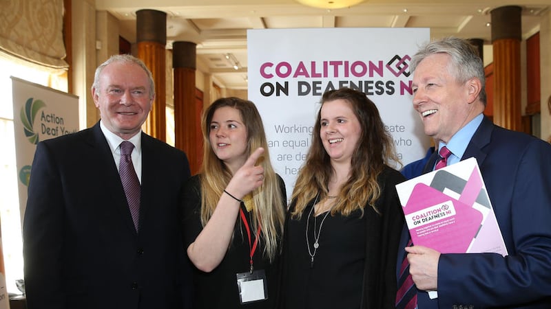 Peter Robinson and Martin McGuinness pictured yesterday at Stormont with the Kelly sisters at the launch of the &#39;Coalition on Deafness.&#39; Pic credit: Hugh Russell. 