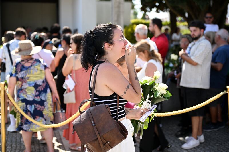 People cried as they made their way to pay their respects