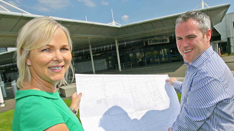Belfast International Airport property manager Katrina Gilchrist and Canice Mallaghan from Moorefield Contracts scan plans for a new &pound;2.5m retail and fuel forecourt adjacent to the airport 