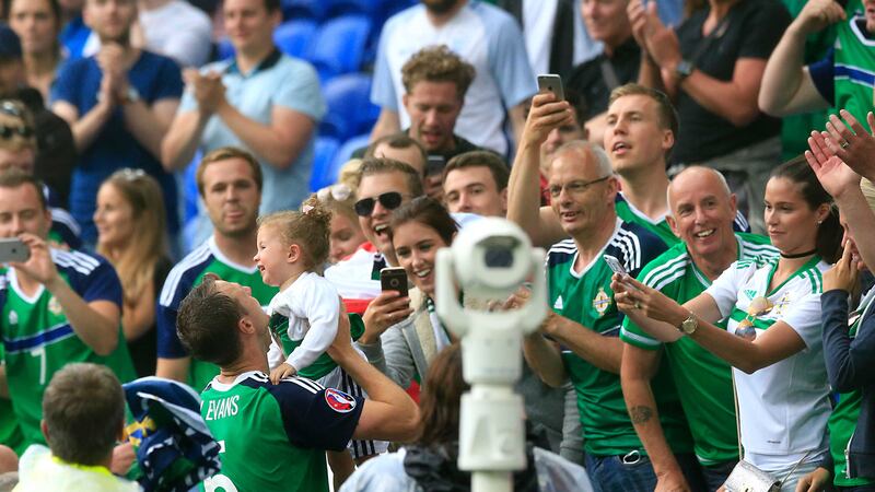 Northern Ireland's Jonny Evans celebrates with his daughter Lottie after the final whistle of the UEFA Euro 2016 win over Ukraine