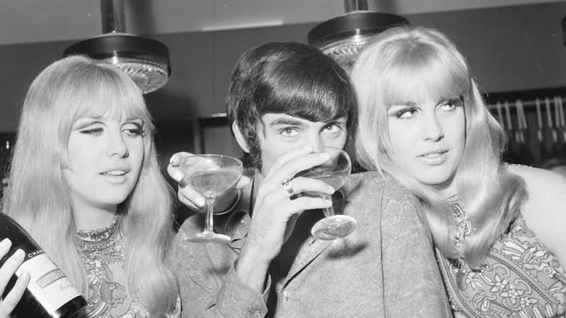 Manchester United footballer George Best celebrates the opening of his fashion boutique with a few glasses of champagne on September 14, 1967 &nbsp;