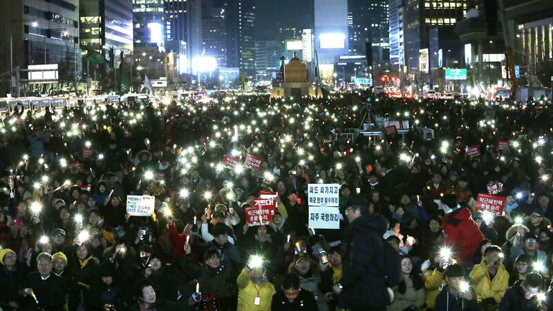 Protesters hold up their smart phone lights during a rally calling for impeached President Park Geun-hye's arrest in Seoul, South Korea, Friday, March 10, 2017. Picture by Ahn Young-joon, Associated Press&nbsp;