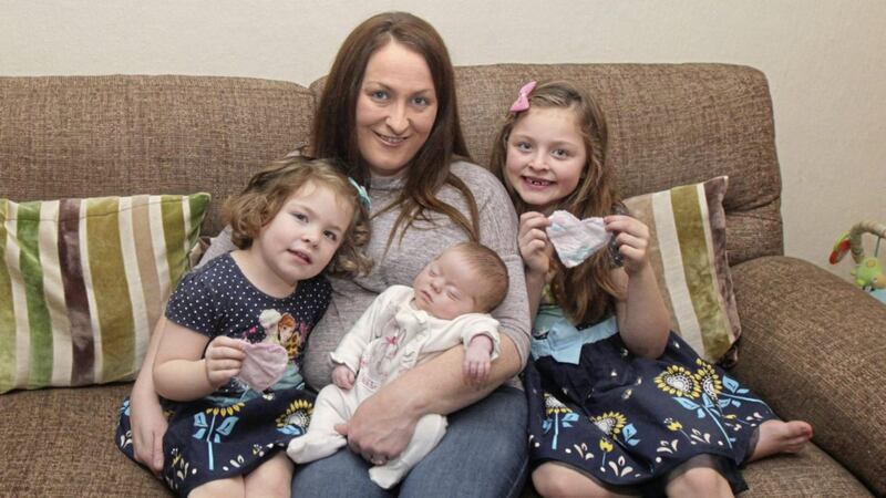 Baby Nancy Baines with mum Louise and sisters Caoimhe and Grace at their home in Co Tyrone, with the cloth hearts that helped mother and baby bond Picture: Margaret McLaughlin 