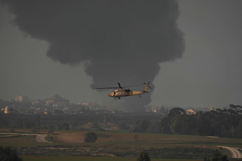 An Israeli military helicopter flies near the Israeli-Gaza border on Monday (Leo Correa/AP)
