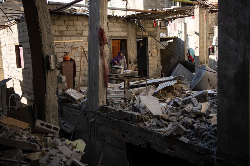 Palestinians look at the destruction after an Israeli strike in Rafah, southern Gaza Strip (Fatima Shbair/AP)