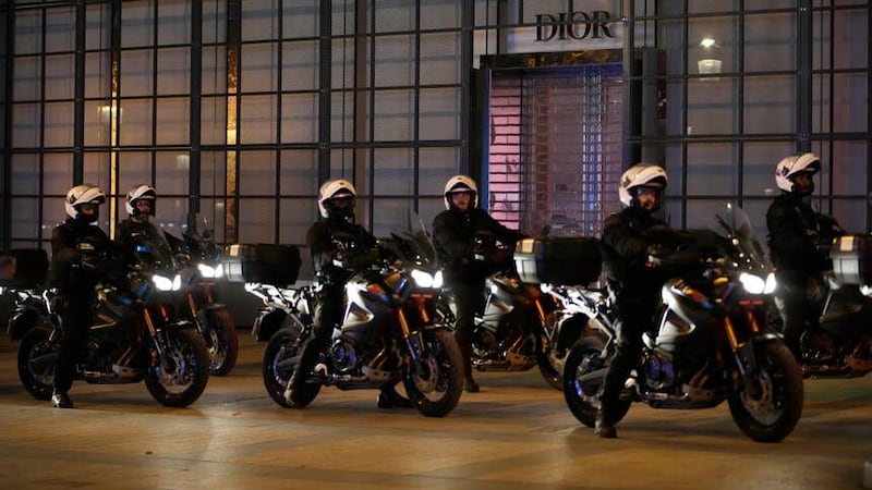Police officers on motorcycles patrol on the Champs Elysees in Paris (Christophe Ena/AP)