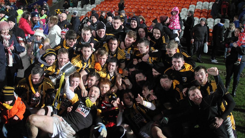 Crossmaglen players and supporters celebrate with the&nbsp;Seamus McFerran Cup