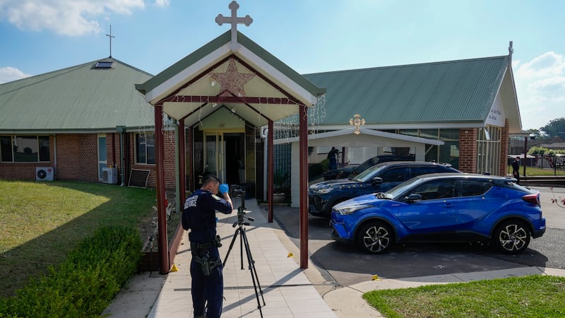 A police forensic officer works at the Christ the Good Shepherd church in Wakely in western Sydney (Mark Baker/AP)