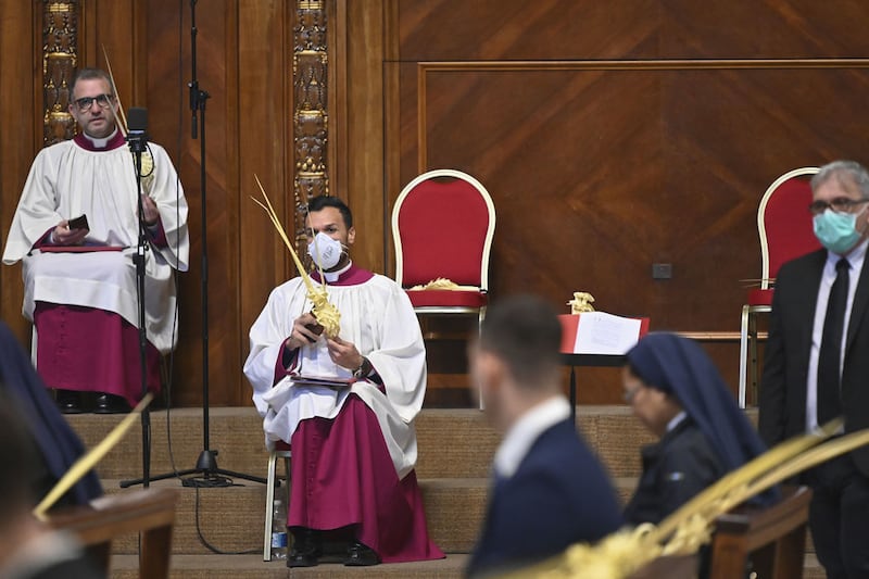 The coronavirus pandemic meant that Palm Sunday Mass took place behind closed doors in St Peter's Basilica, with some wearing face masks. Picture by AP Photo/pool/Alberto Pizzoli