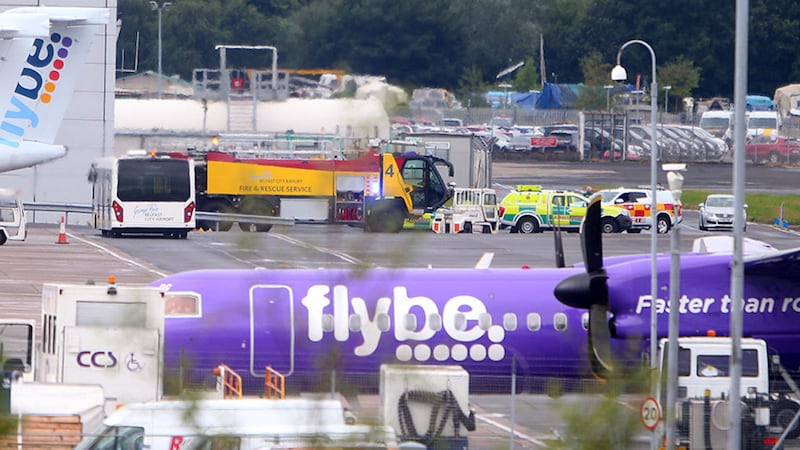 The Flybe plane pictured at Belfast City Airport this morning surrounded by emergency service vehicles. Picture Mal McCann&nbsp;