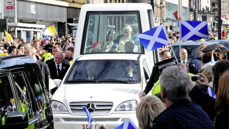Pope Benedict XVI blesses the crowd as he travels down Edinburgh's Princess Street during his 2010 visit to the UK&nbsp;