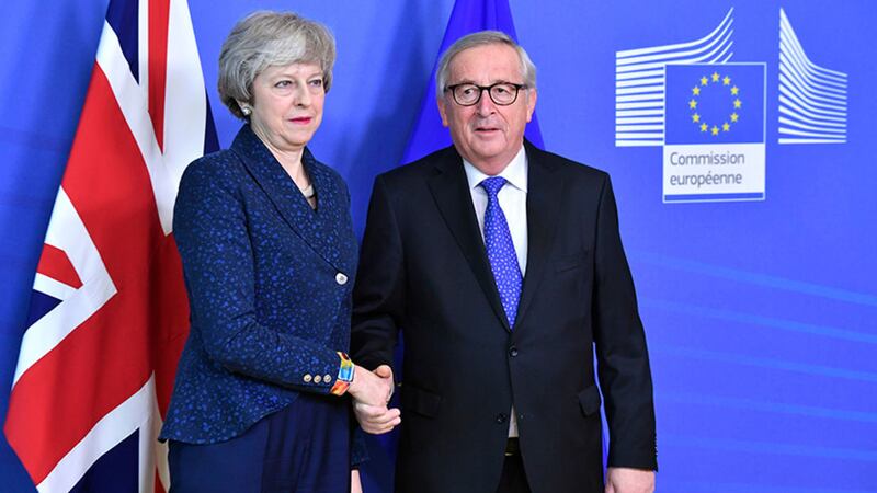 European Commission President Jean-Claude Juncker shakes hands with British Prime Minister Theresa May yesterday before their meeting at the European Commission headquarters in Brussels&nbsp;