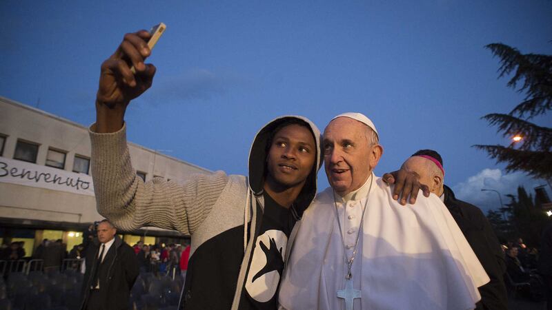 Pope Francis poses for a selfie during his visit at the Castelnuovo di Porto refugees centre, close to Rome. Picture by&nbsp;L'Osservatore Romano via Associated Press&nbsp;