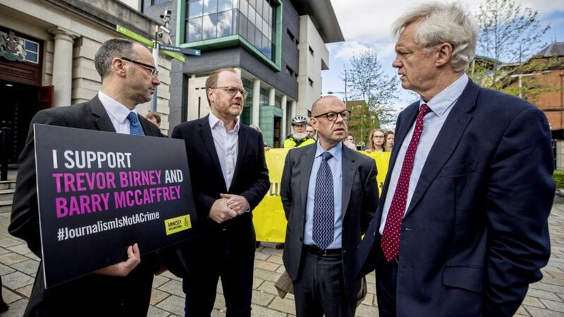 Patrick Corrigan of Amnesty International pictured with journalists Trevor Birney and Barry McCaffrey as they speak with David Davis MP outside Belfast High Court. 