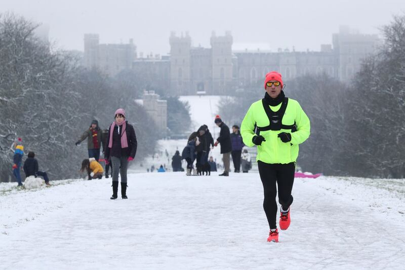 A jogger in the snow on the Long Walk at Windsor Castle, Berkshire 