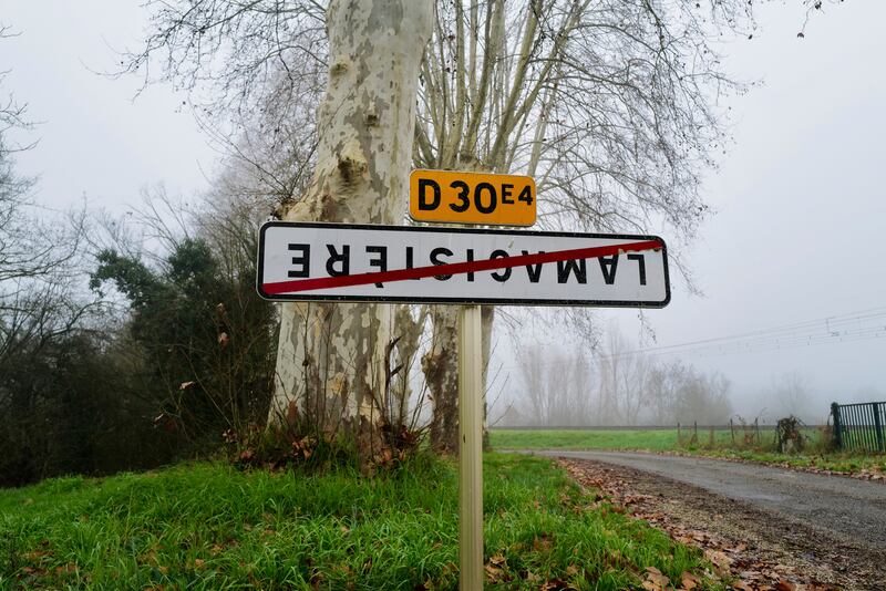 A road sign to the French city of Lamagistere was turned upside down by protesting farmers (AP Photo/Fred Scheiber)