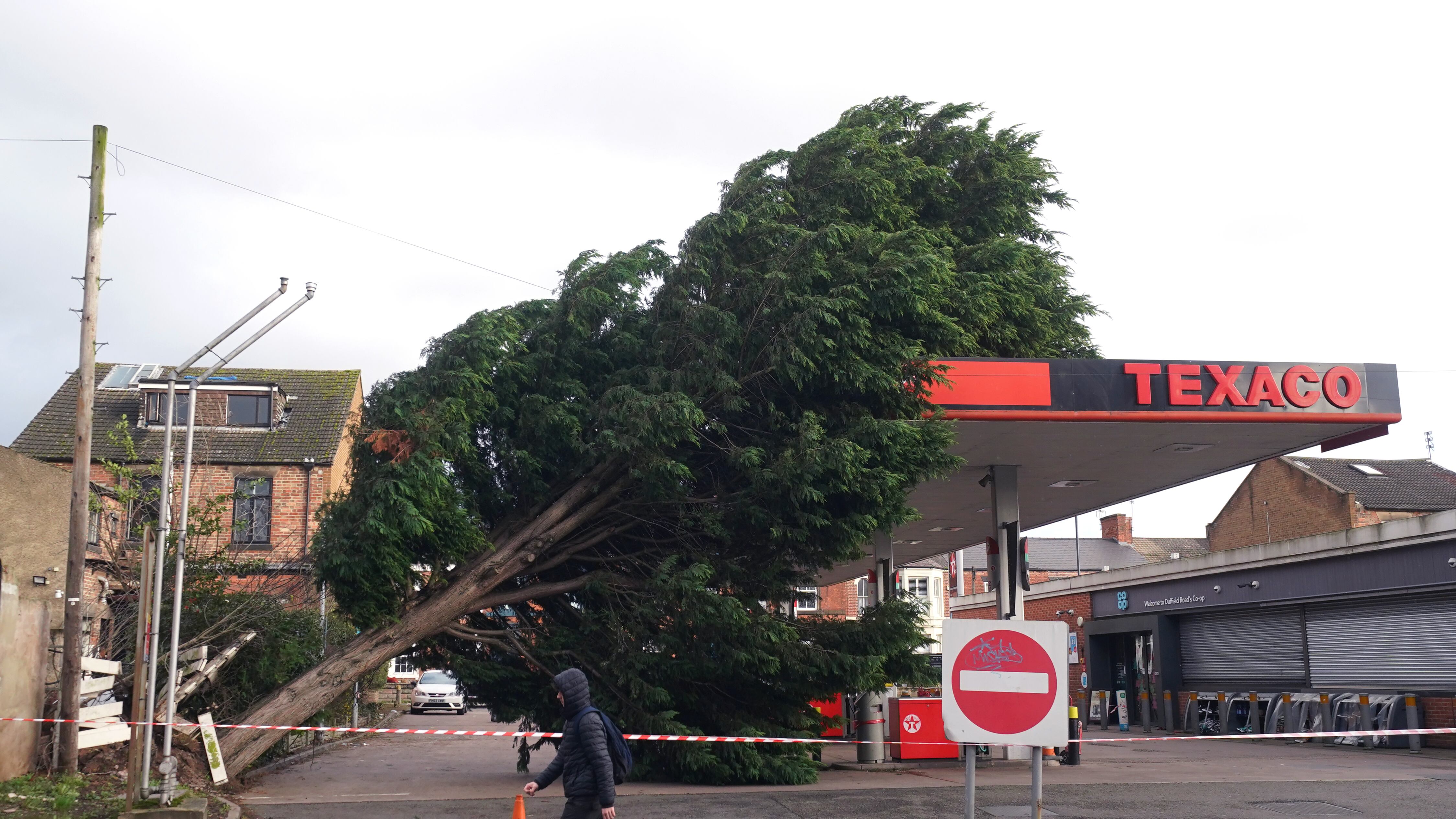 A tree fallen onto the roof of a Texaco petrol station in Derby