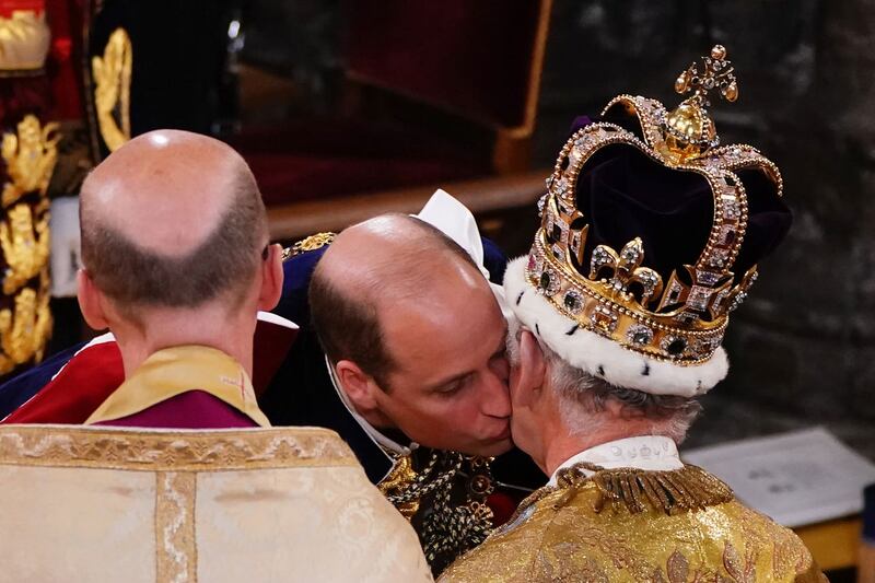 The Prince of Wales kisses his father the King during the coronation ceremony at Westminster Abbey