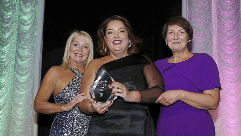Tina McKenzie receives her Business Personality of the Year award from Ann McSorley (right), head of corporate banking at First Trust Bank, and Brenda Buckley (Business Eye). Photo: Darren Kidd/PressEye 