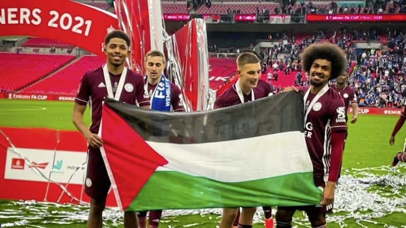 Leicester footballers, Hamza Choudhury and Wesley Fofana, wave a Palestine flag during their FA victory celebrations 