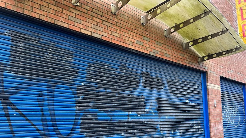 Racist graffiti on the former shoe shop on Sandy Row was quickly painted over 