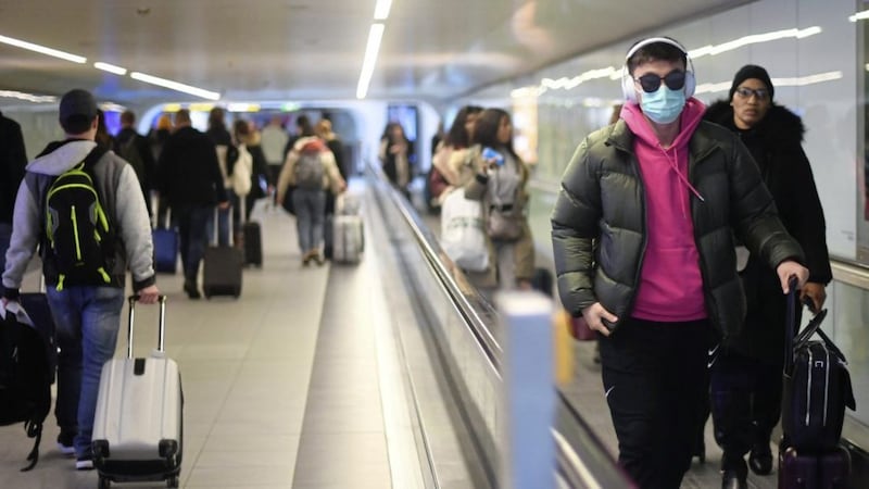 A traveller wearing a face mask at Gatwick Airport in Sussex. Picture by Victoria Jones/PA Wire