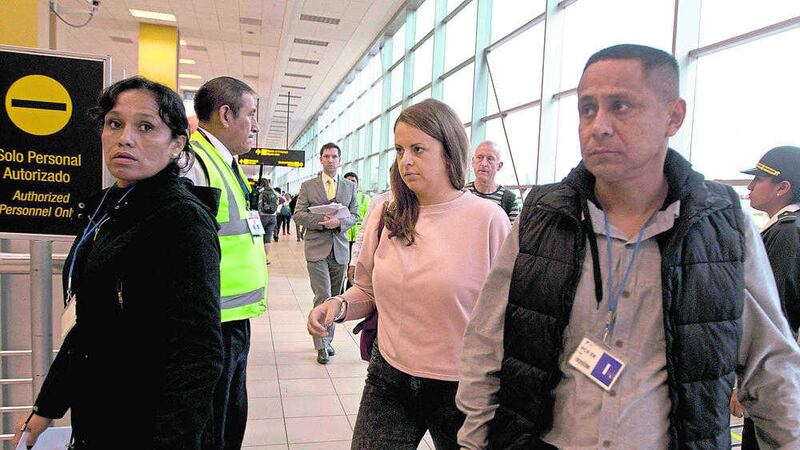 EXTRADITED: Melissa Reid, centre, boards a flight in Lima, Peru on Tuesday         PICTURE: Martin Mejia 