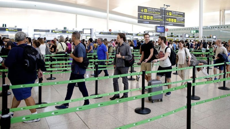 Passengers wait for pass the security control at the Barcelona airport, Spain. Picture by AP Photo/Manu Fernandez 