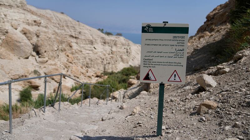 A warning sign near the site of a rockslide that took place in the Ein Gedi Nature Reserve, on the western shore of the Dead Sea, a popular tourist site in Israel (Ohad Zwigenberg/AP)