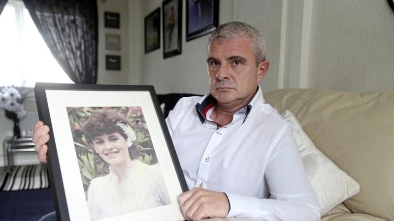 Brendan Duffy holds a photo of his teenage sister Eileen who was one of three Catholics shot dead in a mobile shop in Craigavon in 1991. Picture by Mal McCann. 